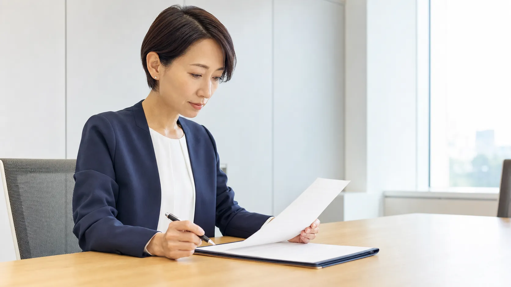 専任契約・非専任契約とテール条項を確認しながら契約書を読む経営者